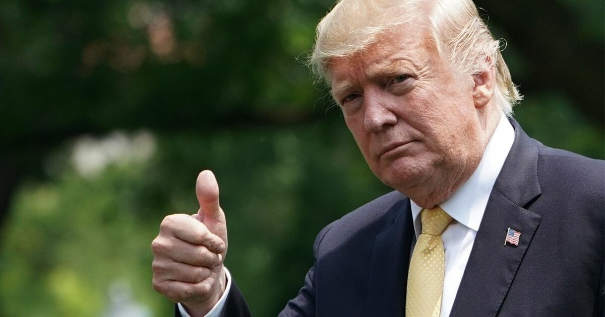 President Donald Trump gives a thumbs up.