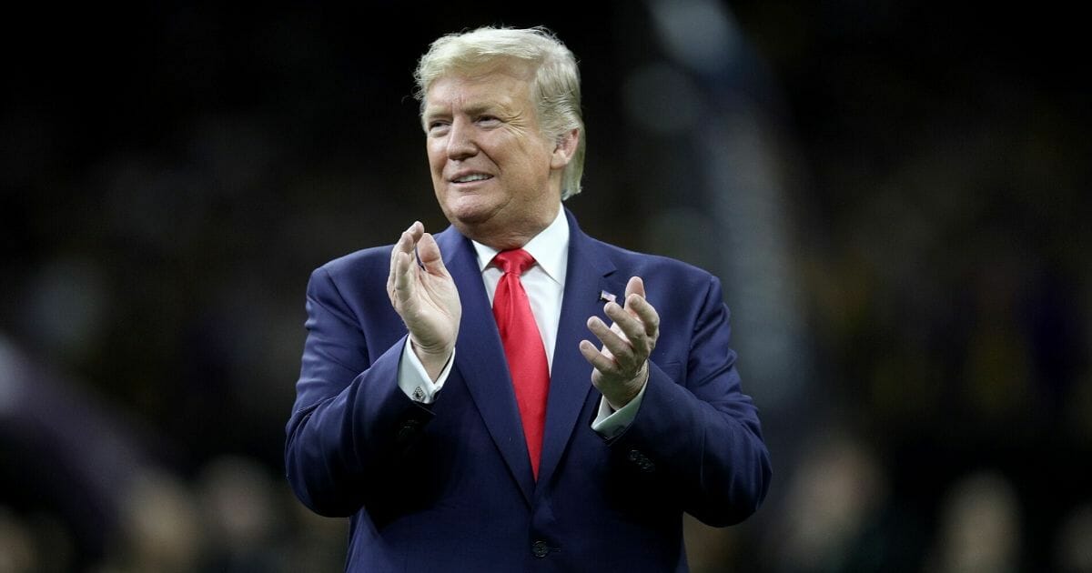 President Donald Trump claps prior to the College Football Playoff national championship game between the Clemson Tigers and the LSU Tigers at the Mercedes Benz Superdome in New Orleans on Jan. 13, 2020.