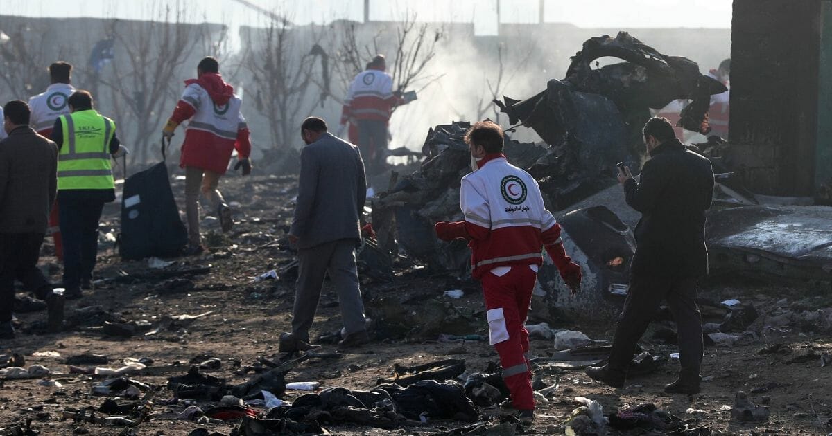 Rescue teams work amid debris after a Ukrainian plane carrying 176 passengers crashed near Imam Khomeini Airport in the Iranian capital Tehran early in the morning on Jan. 8, 2020, killing everyone on board.