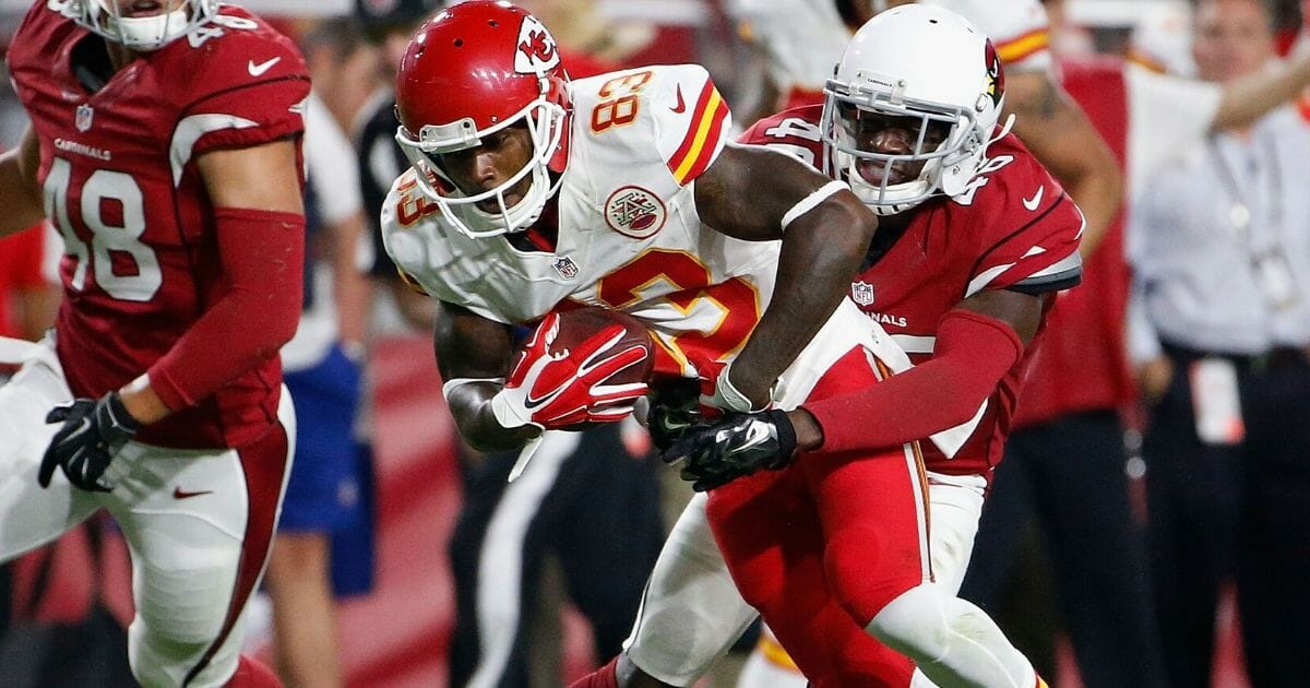 Wide receiver Fred Williams #83 of the Kansas City Chiefs is tackled by defensive back Jimmy Legree #46 of the Arizona Cardinals during the preseason NFL game at the University of Phoenix Stadium on Aug. 15, 2015, in Glendale, Arizona.