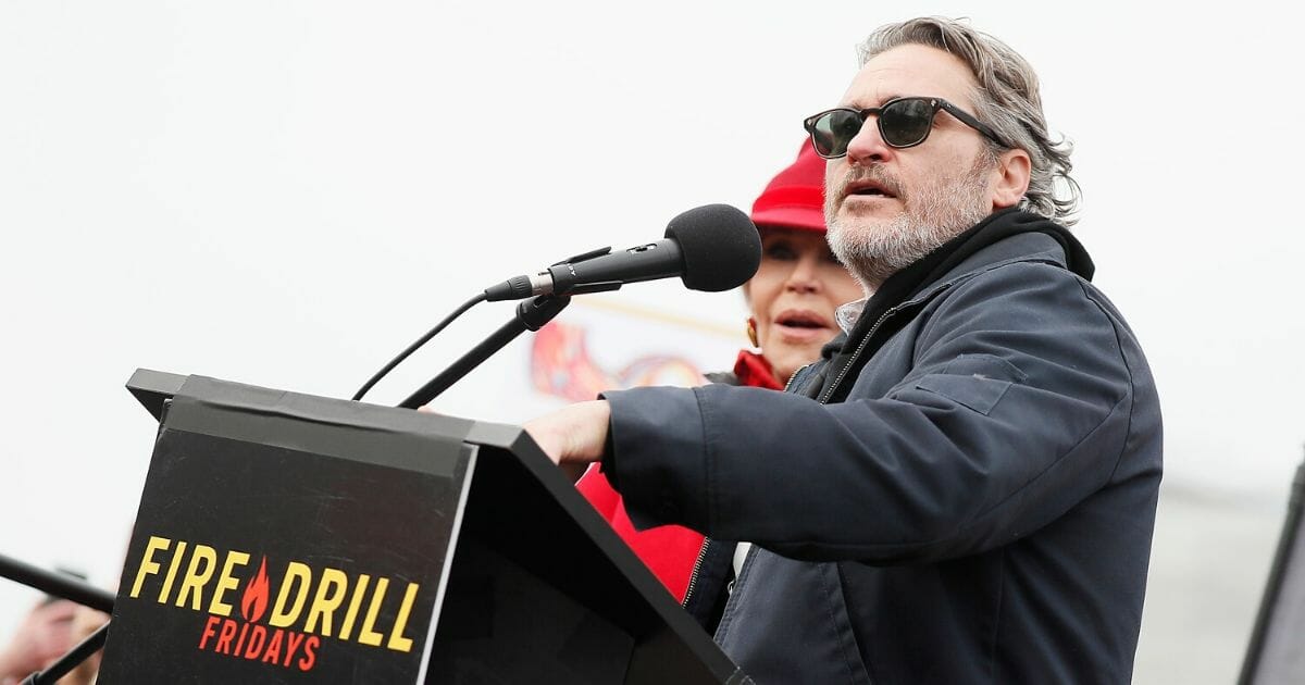 Actor Joaquin Phoenix, right, onstage with actress and activist Jane Fond during the last "Fire Drill Fridays" climate change protest and rally on Capitol Hill on Jan. 10, 2020, in Washington, D.C.