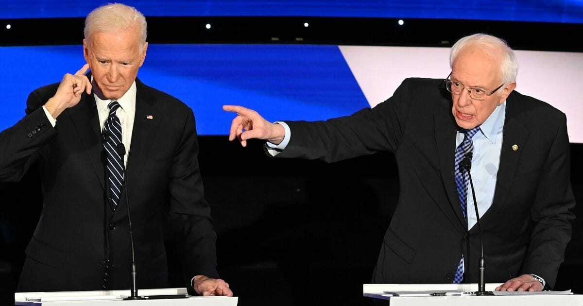 Former Vice President Joe Biden and Vermont Sen. Bernie Sanders square off during a Democratic presidential primary debate at the Drake University campus in Des Moines, Iowa, on Jan. 14, 2020.