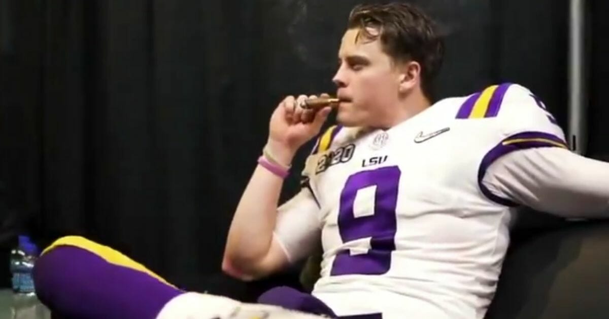 LSU quarterback Joe Burrow enjoys a cigar after his team wins the national championship.