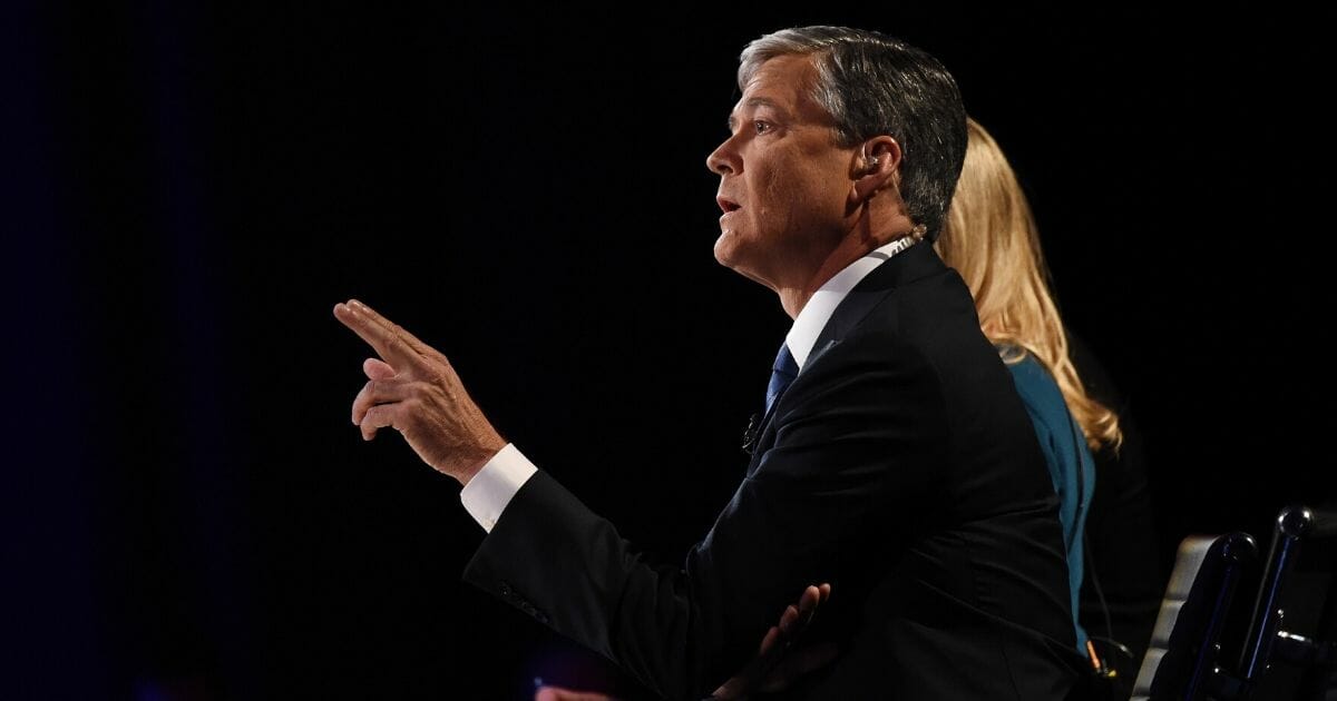 Debate moderator John Harwood questions candidates at the third Republican presidential debate hosted by CNBC on Oct. 28, 2015, at the Coors Event Center at the University of Colorado in Boulder, Colorado.