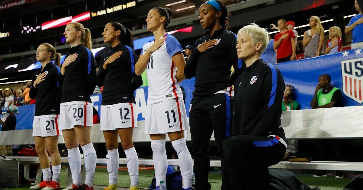 Megan Rapinoe #15 kneels during the national anthem prior to the match between the United States and the Netherlands at the Georgia Dome on Sept. 18, 2016, in Atlanta, Georgia.