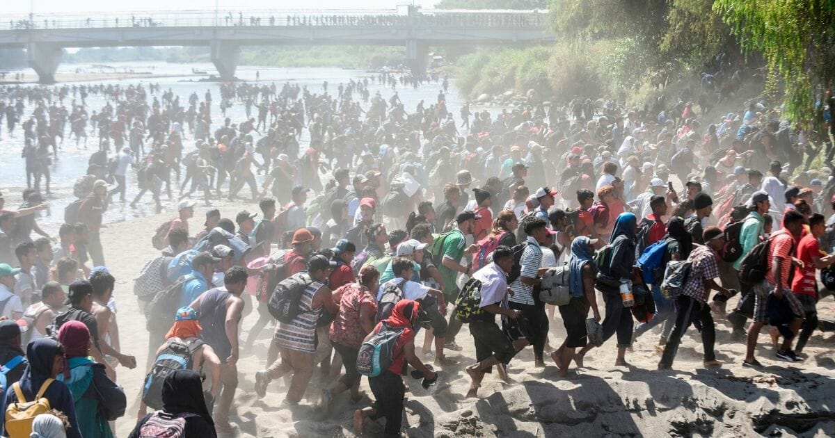 Central American migrants traveling in a caravan to the U.S. border rush across the Suchiate River between Guatemala and Mexico on Jan. 20, 2020.