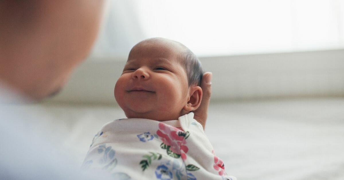 A stock photo of a newborn baby is seen above.