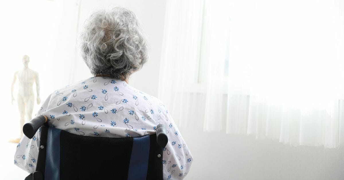 In the stock image above, an elderly woman sits in a wheelchair.