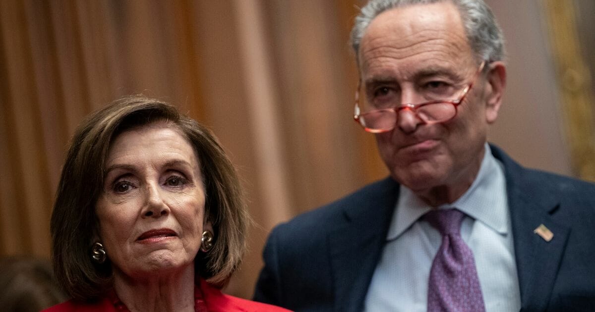 Speaker of the House Nancy Pelosi and Senate Minority Leader Chuck Schumer look on during a news conference at the U.S. Capitol in Washington on Nov. 12, 2019.