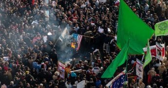Mourners burn U.S. and Israeli flags during a funeral ceremony for Iranian Major General Qassem Soleimani and others who were killed in Iraq by a U.S. drone strike on Jan. 6, 2020, in Tehran, Iran.