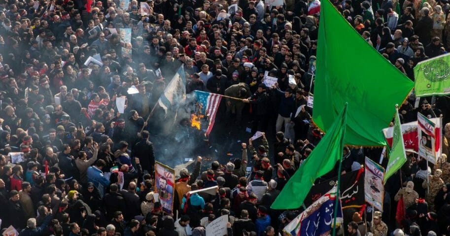 Mourners burn U.S. and Israeli flags during a funeral ceremony for Iranian Major General Qassem Soleimani and others who were killed in Iraq by a U.S. drone strike on Jan. 6, 2020, in Tehran, Iran.