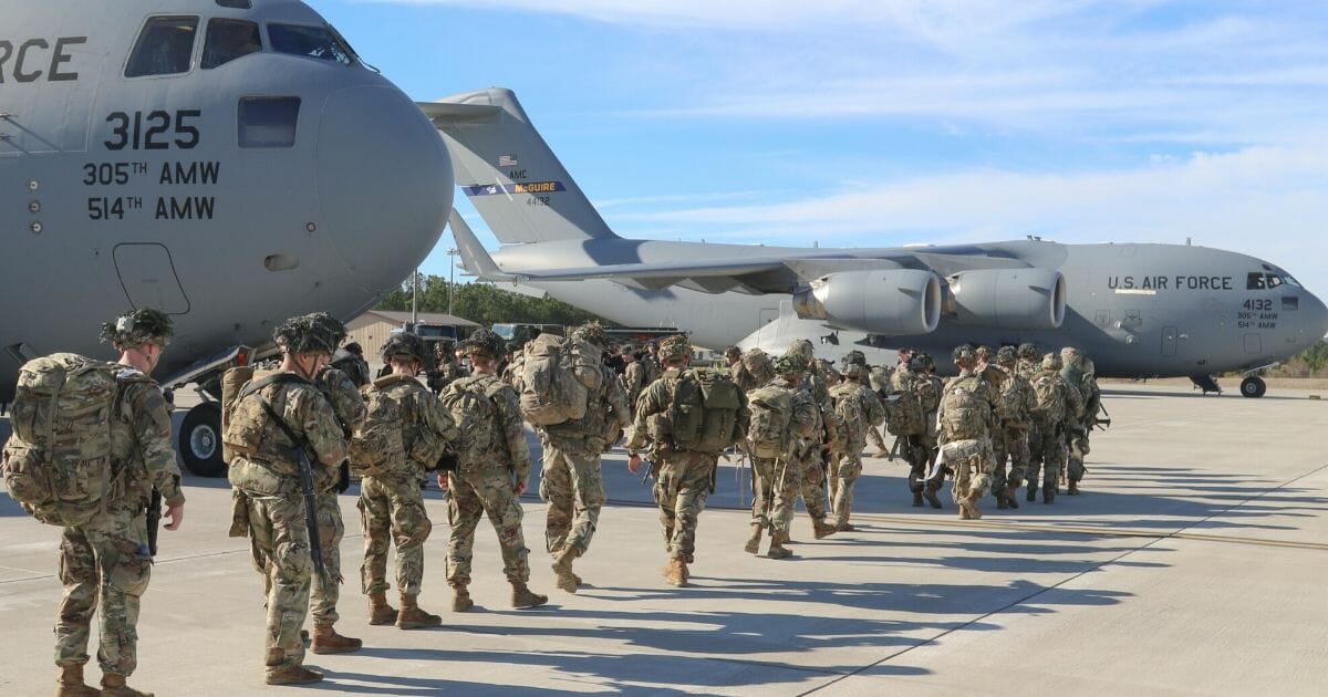 This handout picture released by the US Army shows U.S. Army paratroopers assigned to the 2nd Battalion, 504th Parachute Infantry Regiment, 1st Brigade Combat Team, 82nd Airborne Division, deploy from Pope Army Airfield, North Carolina, on Jan. 1, 2020.