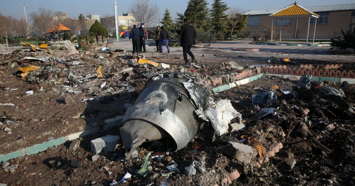 Rescue teams work amid debris after a Ukrainian plane carrying 176 passengers crashed near Imam Khomeini Airport in the Iranian capital Tehran early in the morning on Jan. 8, 2020, killing everyone on board.