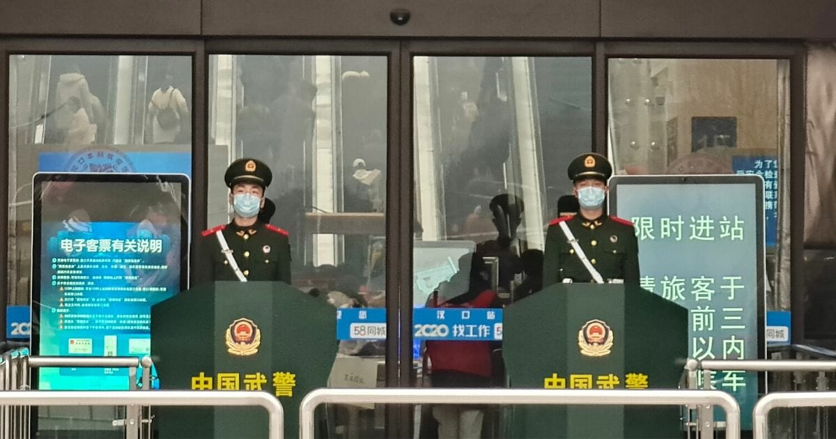 Guards wearing face masks stand at Hankou Railway Station on Jan. 22, 2020, in Wuhan, China.