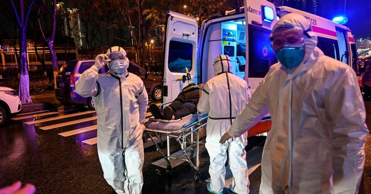 Medical workers in Wuhan, China escort a patient that may have the novel coronavirus.