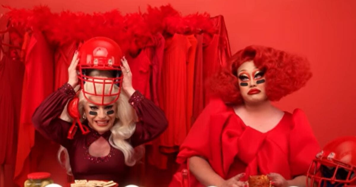 Two drag queens attempt to sell hummus.