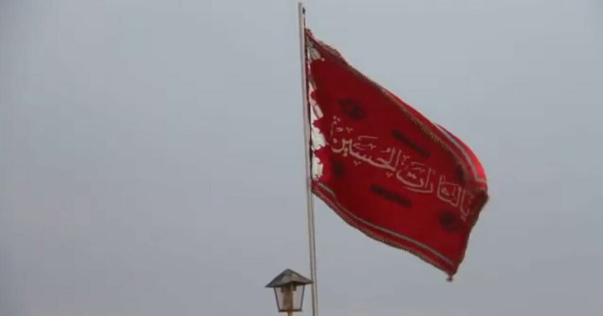 A red flag, raised over Iran's Jamkaran mosque.