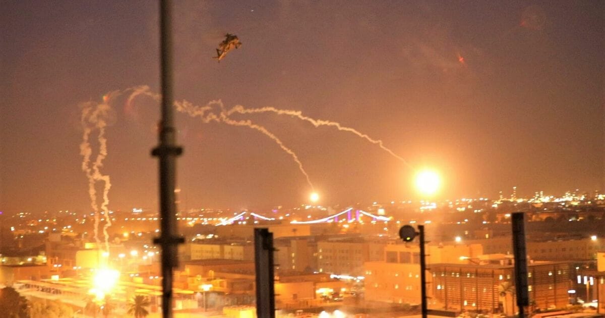 A handout picture received from the U.S. embassy in Iraq on Dec. 31, 2019, shows a U.S. Army Apache helicopter dropping flares over Baghdad's high-security Green Zone after Iraqi militants of pro-Iran factions breached the outer wall of the embassy.