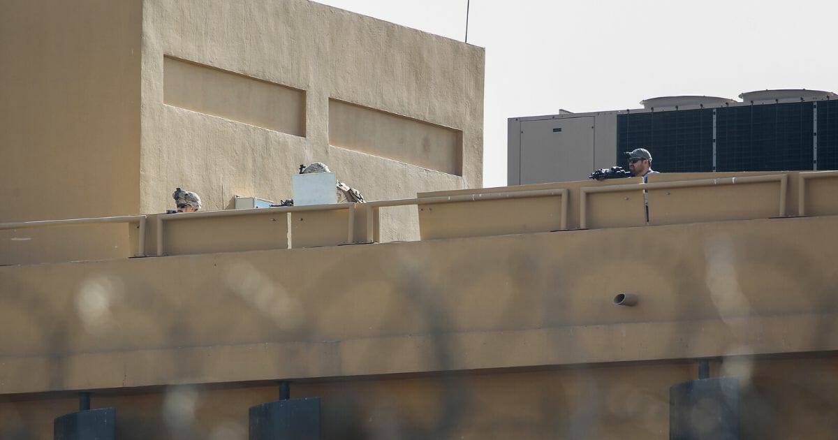 U.S. forces stand guard at the roof of the US embassy in the Iraqi capital Baghdad on Wednesday during a demonstration by Iranian supported militants.