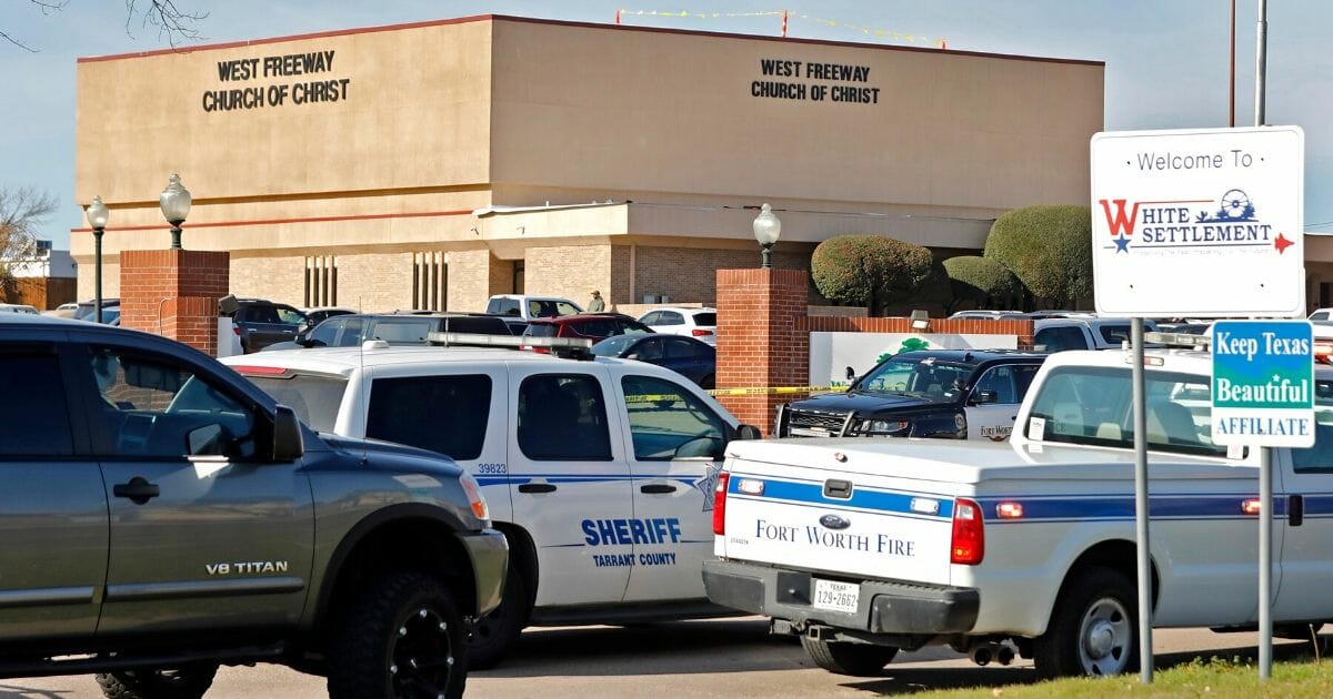 Law enforcement vehicles parked outside West Freeway Church of Christ in White Settlement, Texas, after a gunman was killed Sunday by armed members of the church's volunteer security team.