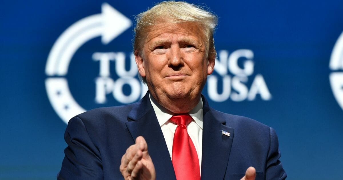 President Donald Trump claps during the Turning Point USA Student Action Summit at the Palm Beach County Convention Center in West Palm Beach, Florida, on Dec. 21, 2019.