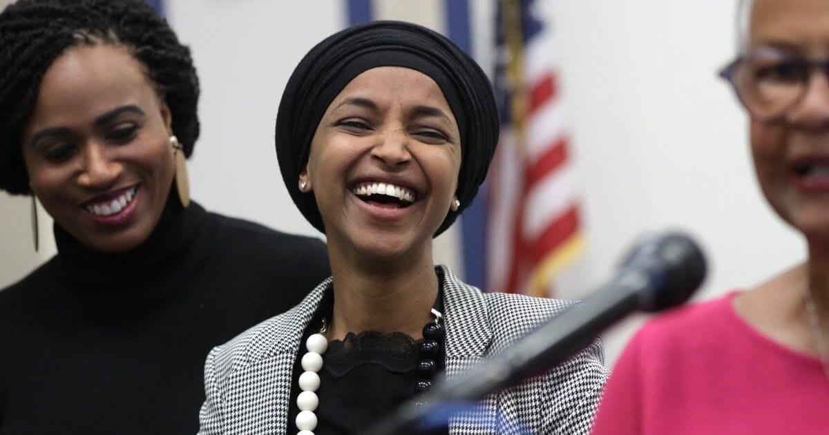 U.S. Rep. Ilhan Omar laughs in a file photo from a December news conference.