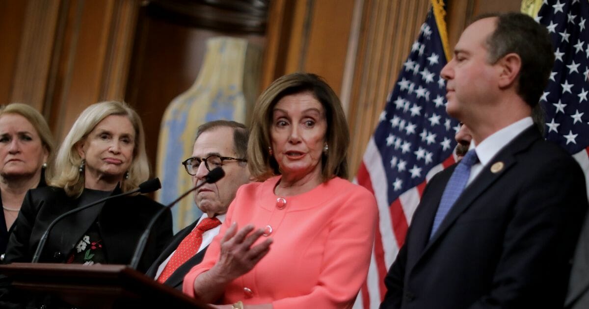 Speaker of the House Nancy Pelosi makes brief remarks before signing the articles of impeachment against President Donald Trump with Texas Rep. Sylvia Garcia, left, New York Reps. Carolyn Maloney and Jerrold Nadler and California Rep. Adam Schiff.