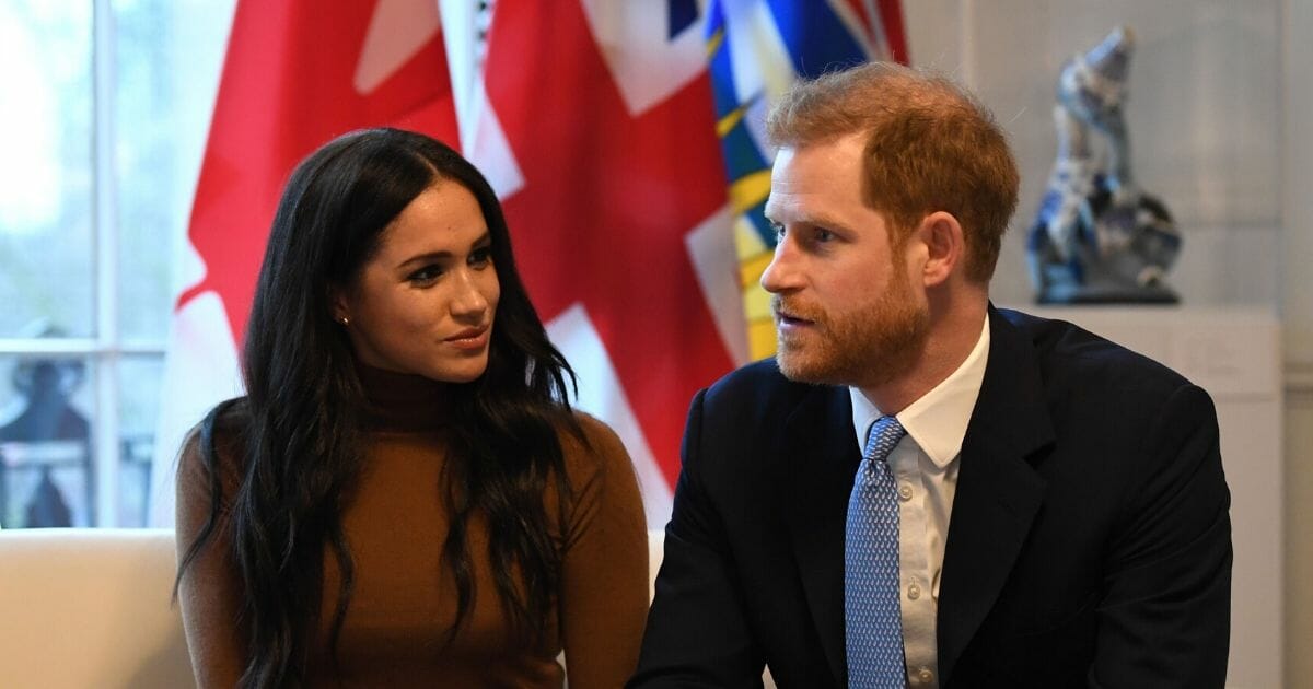 Britain's Prince Harry, Duke of Sussex, and Meghan, Duchess of Sussex, gesture during their visit to Canada House in London on Jan. 7, 2020.