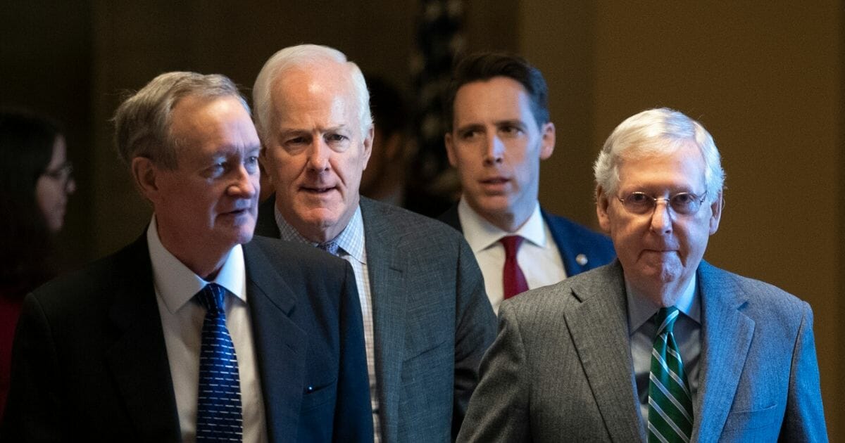 Republican Sens. Sen. Mike Crapo of Idaho, John Cornyn of Texas and Josh Hawley of Missouri and Senate Majority Leader Mitch McConnell leave McConnell's office and walk to the Senate chamber for impeachment proceedings at the U.S. Capitol on Jan. 16, 2020 in Washington, D.C.