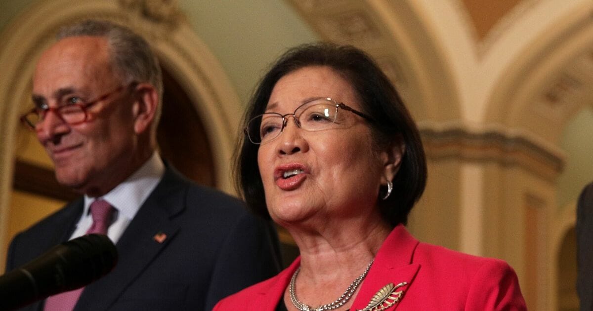 Democratic Sen. Mazie Hirono of Hawaii speaks as Senate Minority Leader Chuck Schumer listens during a news briefing after the weekly Senate Democratic policy luncheon on Sept. 10, 2019, at the U.S. Capitol in Washington, D.C.