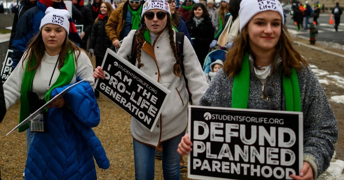 Pro-life students and activists carry signs during the annual March for Life in Washington, D.C., on Jan. 18, 2019.