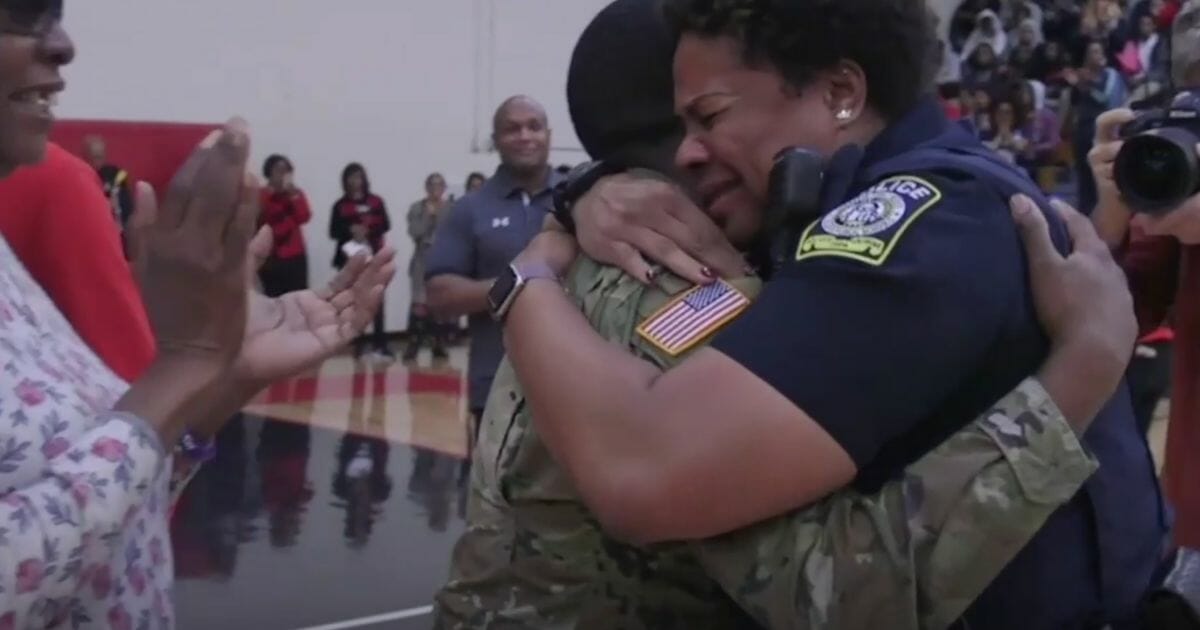 U.S. Army Spc. Shakir Aquil surprises his mother, retired police officer L.J. Williamson, at D.M. Therrell High School in Atlanta.