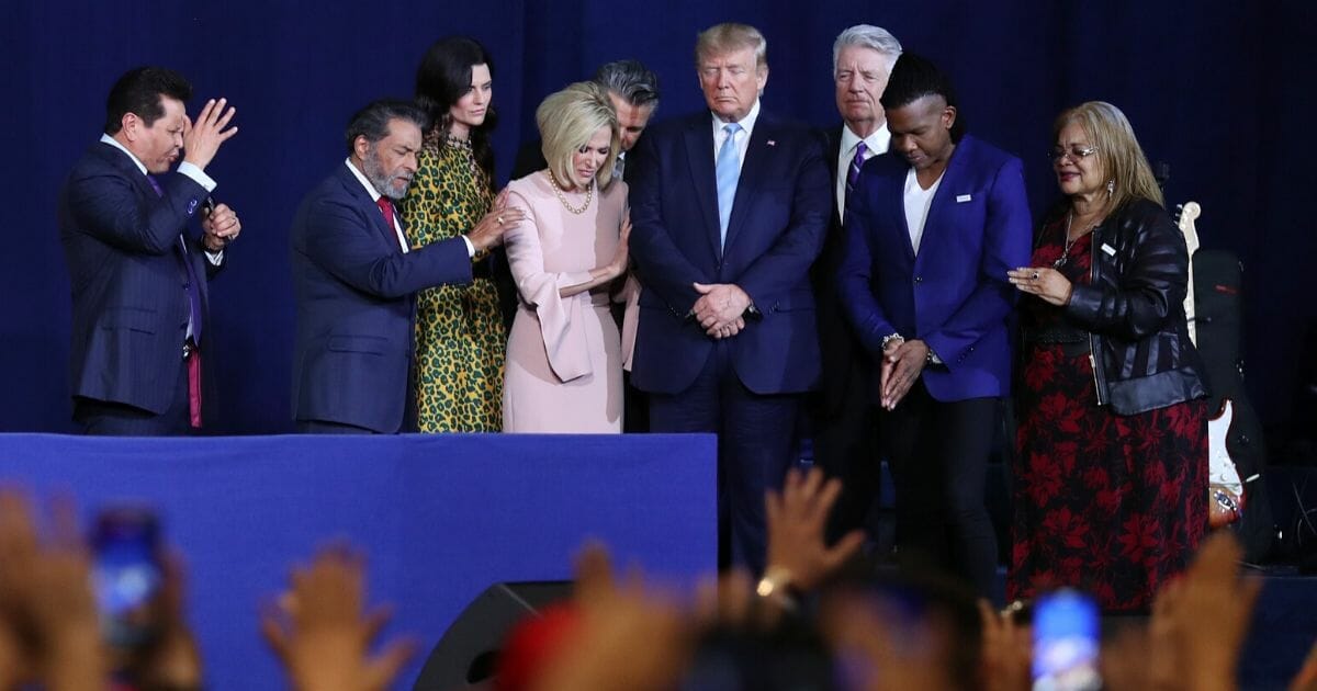 Faith leaders pray over President Donald Trump during a "Evangelicals for Trump" campaign event held at the King Jesus International Ministry on Jan. 3, 2020, in Miami.