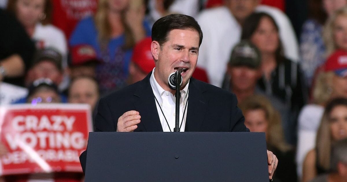 Arizona Gov. Doug Ducey speaks during a campaign rally in October 2018 at the International Air Response facility in Mesa, Arizona.