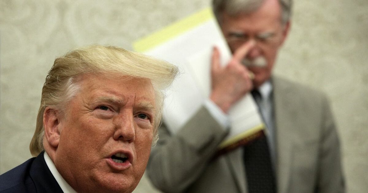 President Donald Trump is pictured with then-National Security Adviser John Bolton during an August meeting at the White House.