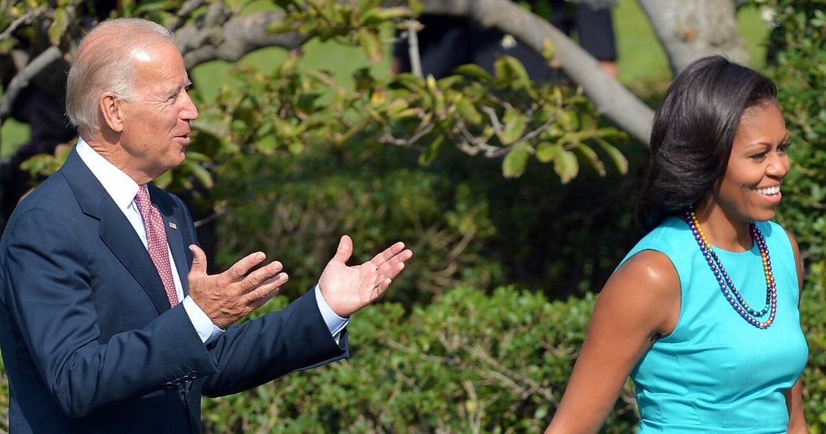 Then-Vice President Joe Biden and first lady Michelle Obama arrive on the South Lawn of the White House in Washington, D.C., on Sept. 14, 2012, during a ceremony to honor the 2012 US Olympic and Paralympic teams.