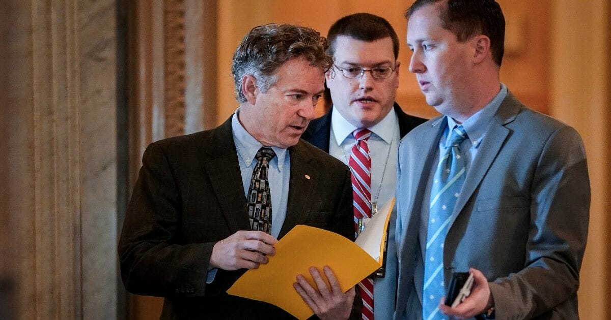 Kentucky Sen. Rand Paul arrives for a news conference Thursday after Chief Justice John Roberts declined to read aloud a Paul question at President Donald Trump's impeachment trial.