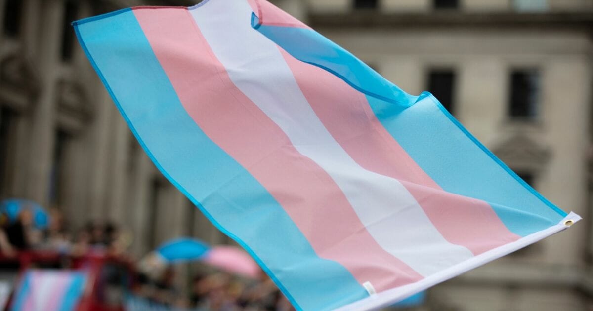 Stock image of a transgender flag being waved.