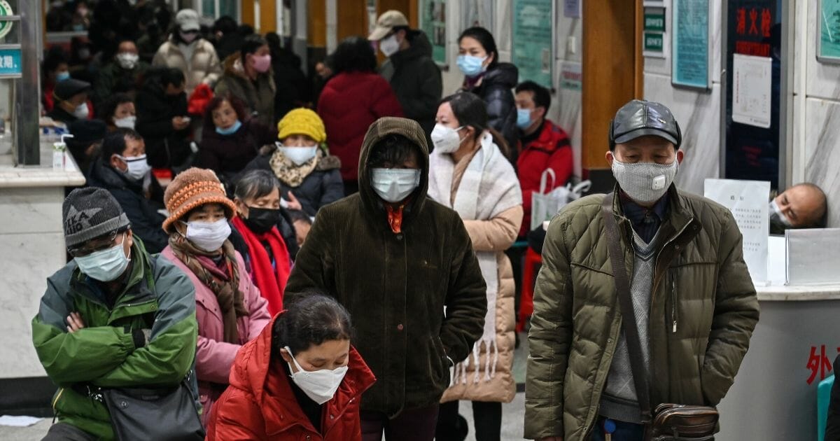 People wearing facemasks to help stop the spread of the deadly coronavirus wait for medical attention at Wuhan Red Cross Hospital in Wuhan, China, on Jan. 25, 2020