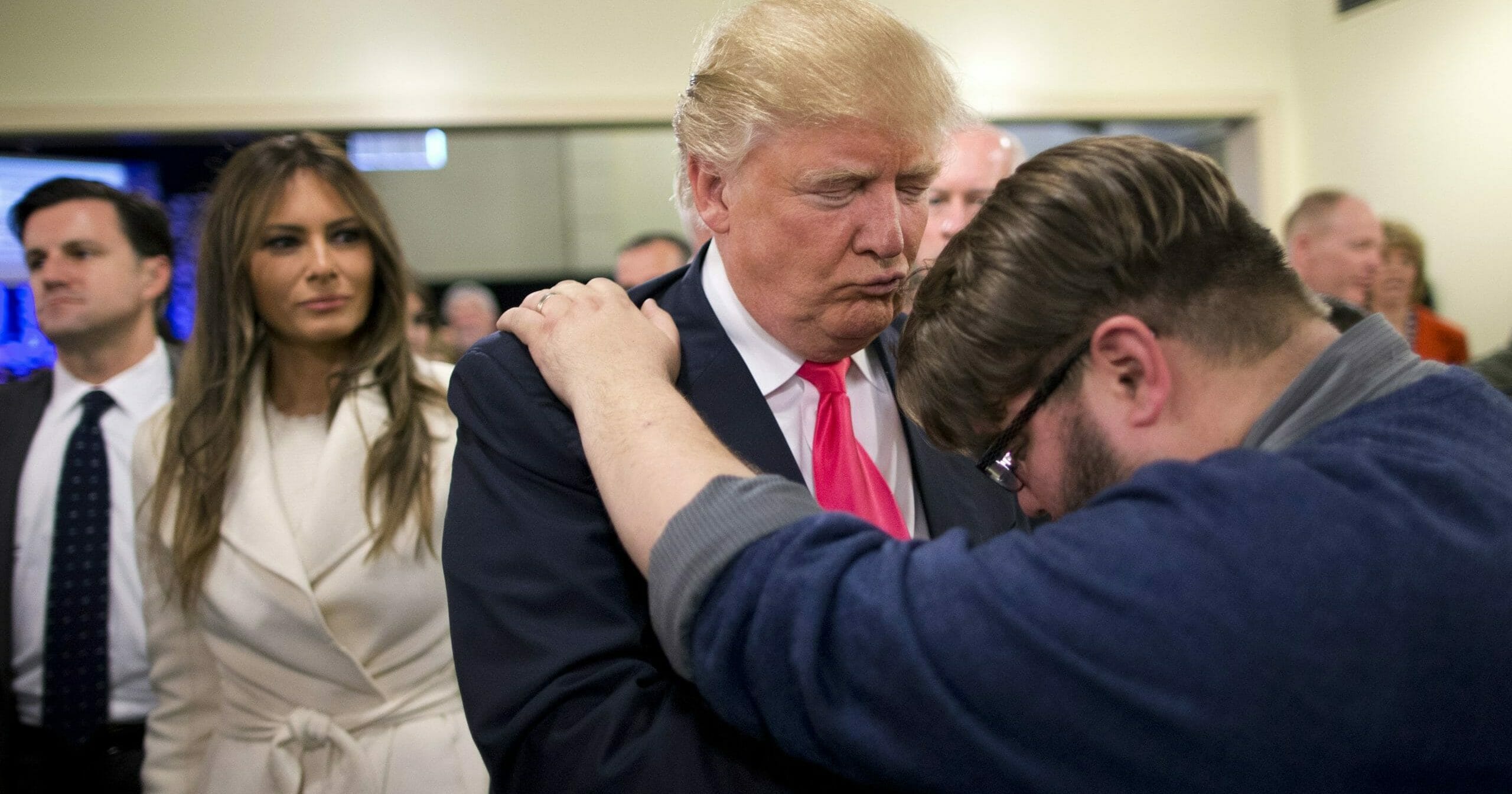 In this Jan. 31, 2016, file photo, Pastor Joshua Nink, right, prays for then-Republican presidential candidate Donald Trump, as his wife, Melania, left, watches after a Sunday service at First Christian Church in Council Bluffs, Iowa. In his first campaign move of the 2020 election year, President Donald Trump on Friday will launch a coalition of evangelicals as he aims to shore up and expand support from an influential piece of his political base.