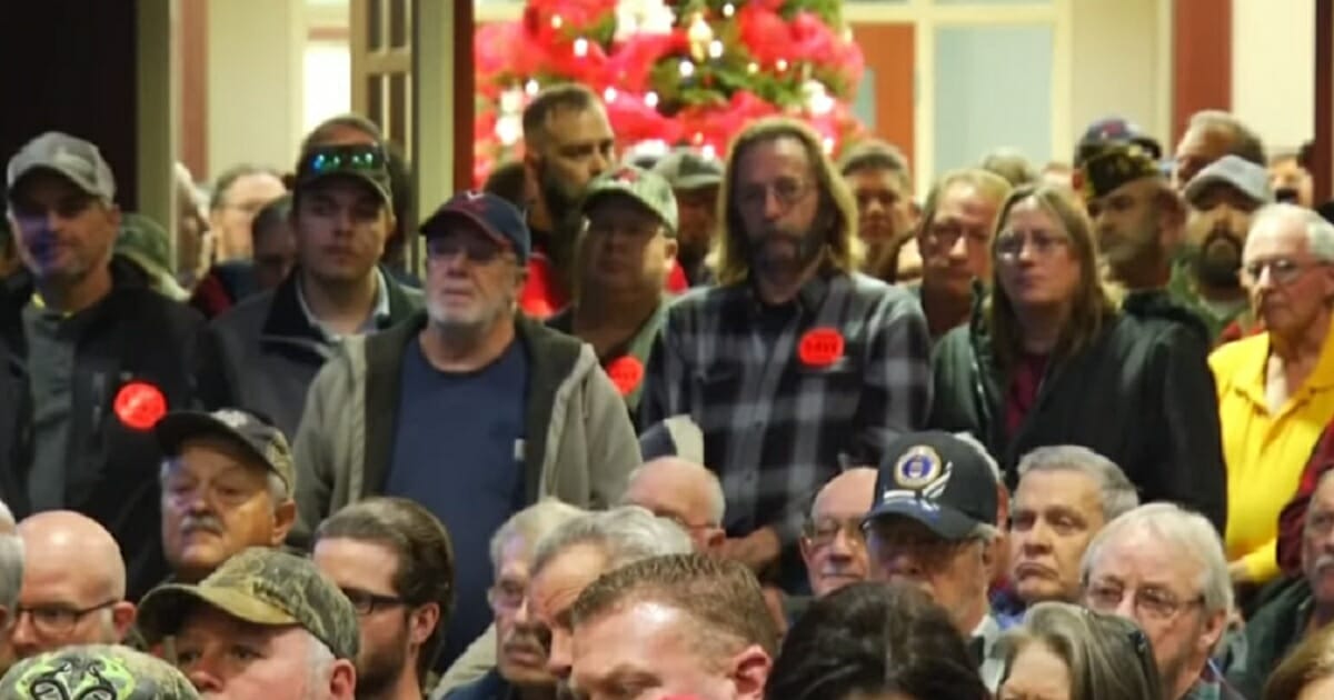 Gun rights supporters sporting stickers that say "Guns save lives" turned out Monday in Virginia's Capitol in Richmond.