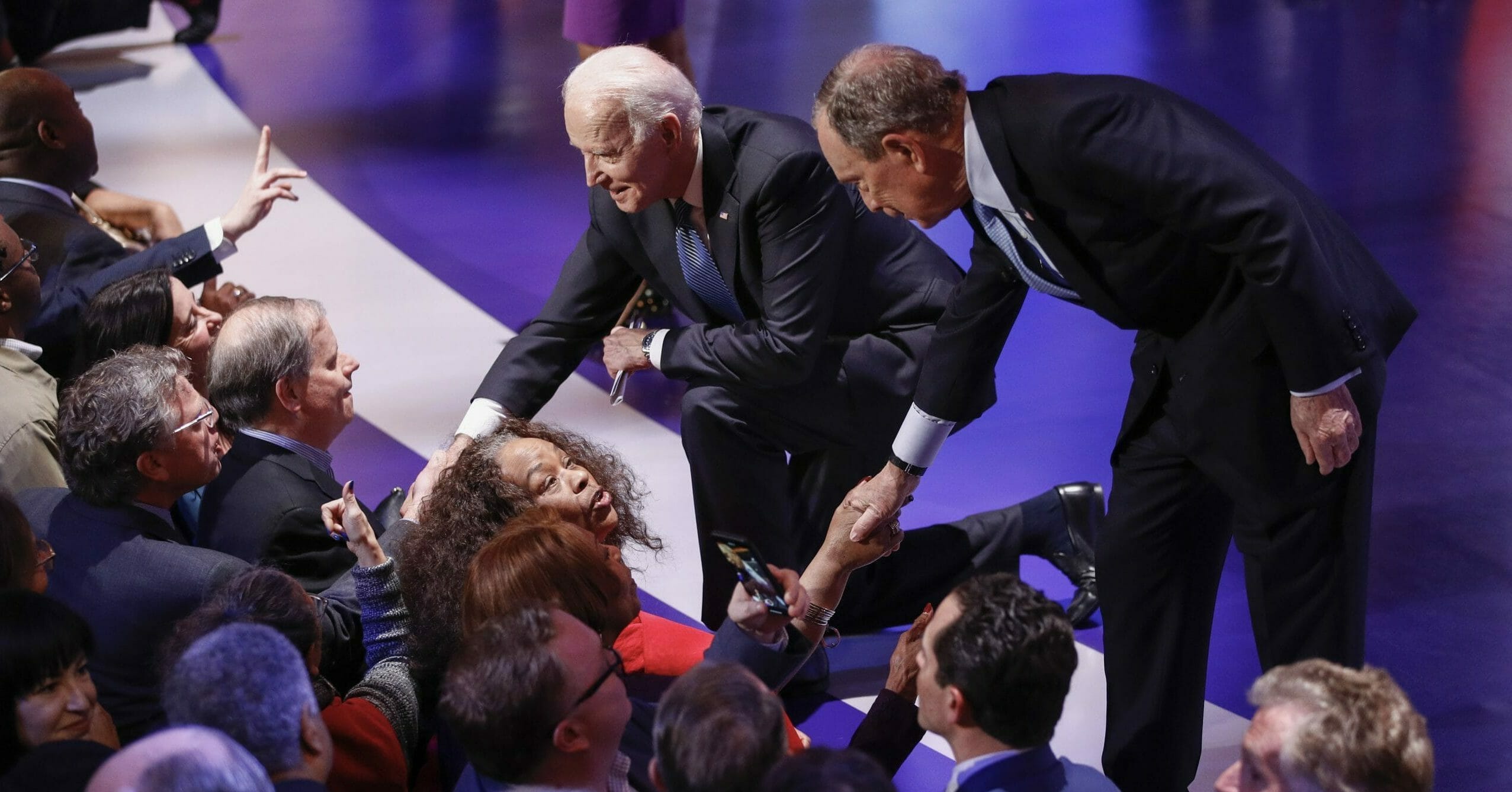 Democratic presidential candidates Mike Bloomberg, right, and Joe Biden greet supporters at the end of the Democratic primary debate at the Gaillard Center in Charleston, South Carolina, on Feb. 25, 2020.