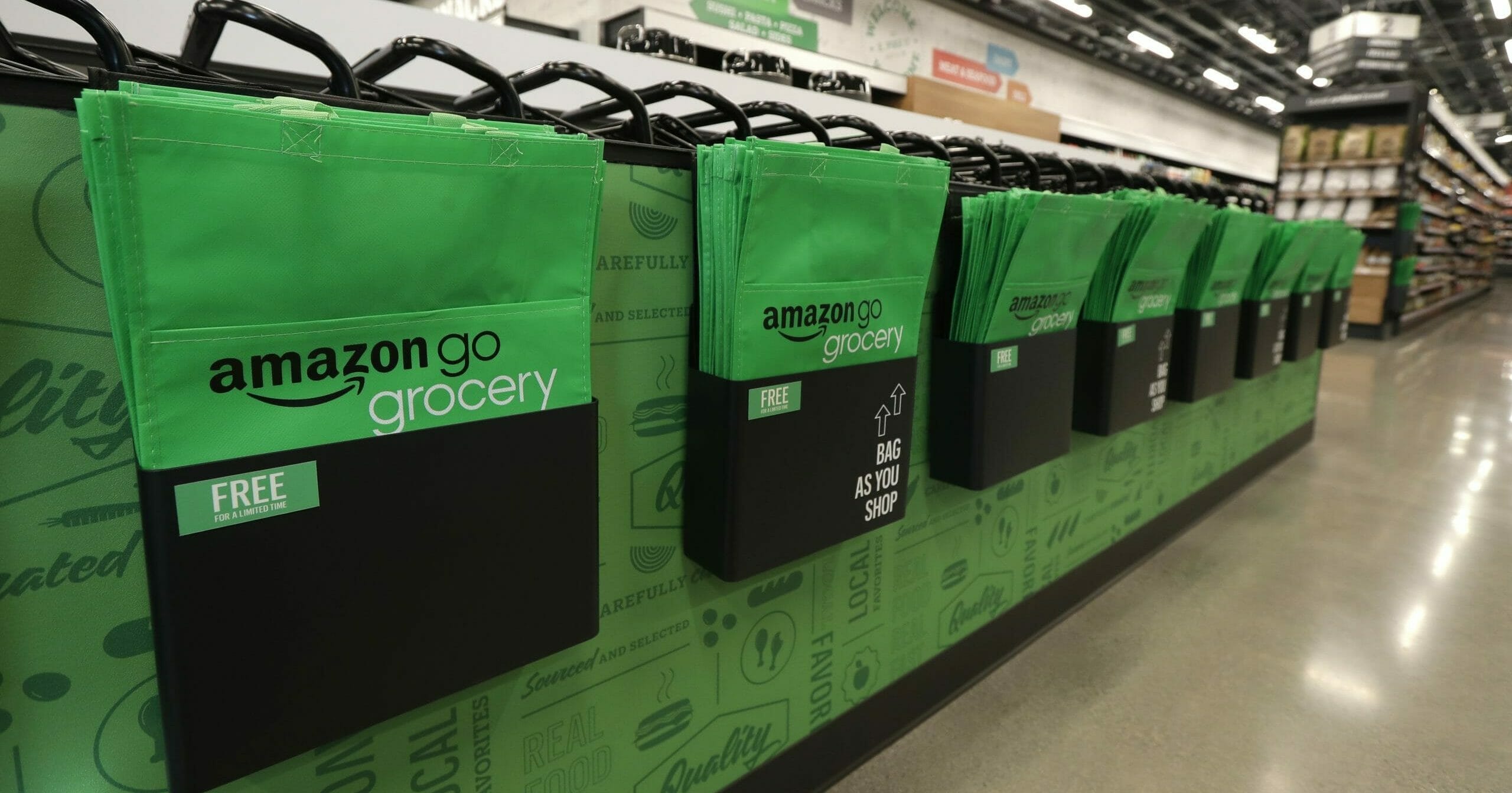 In this Feb. 21, 2020 photo, reusable shopping bags are displayed inside an Amazon Go Grocery store set to open soon in Seattle's Capitol Hill neighborhood.