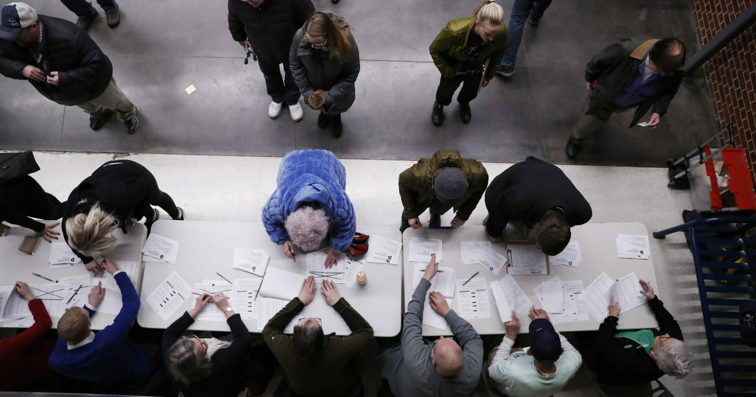 Iowa caucusgoers check in at Roosevelt High School in Des Moines on Feb. 3, 2020.