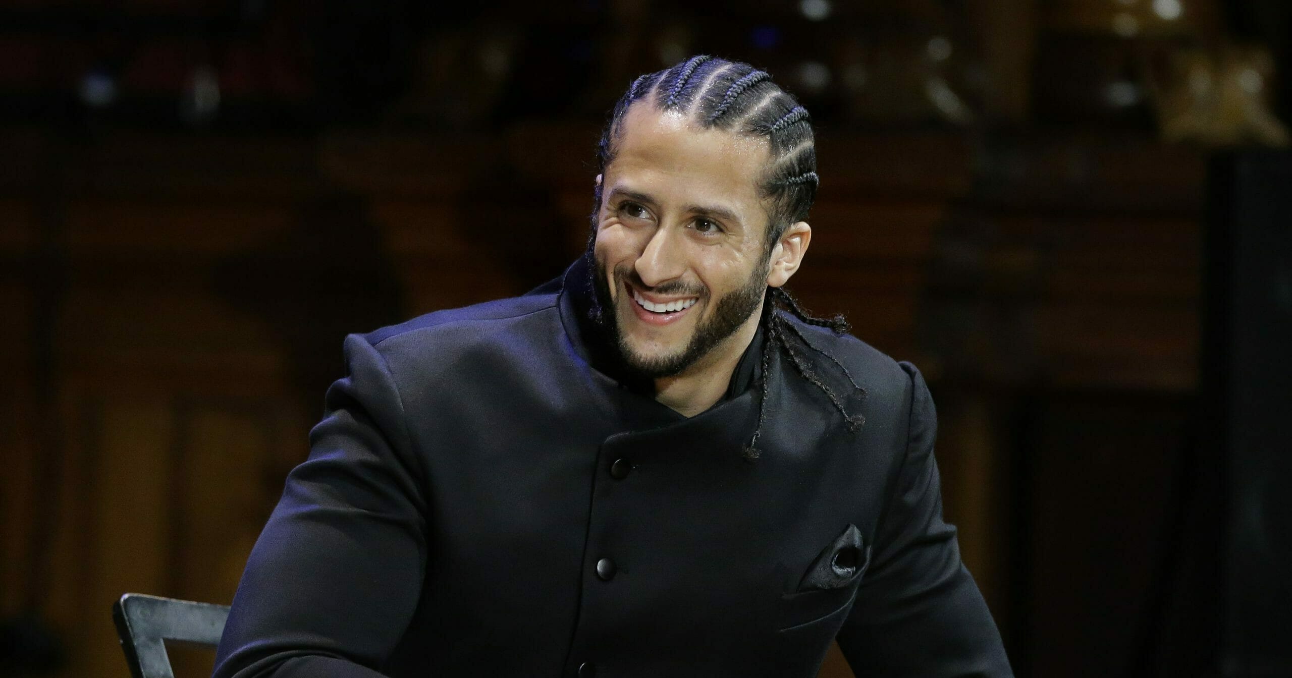 In this Oct. 11, 2018, file photo, former NFL football quarterback Colin Kaepernick smiles onstage during the W.E.B. Du Bois Medal ceremonies at Harvard University in Cambridge, Massachusetts.