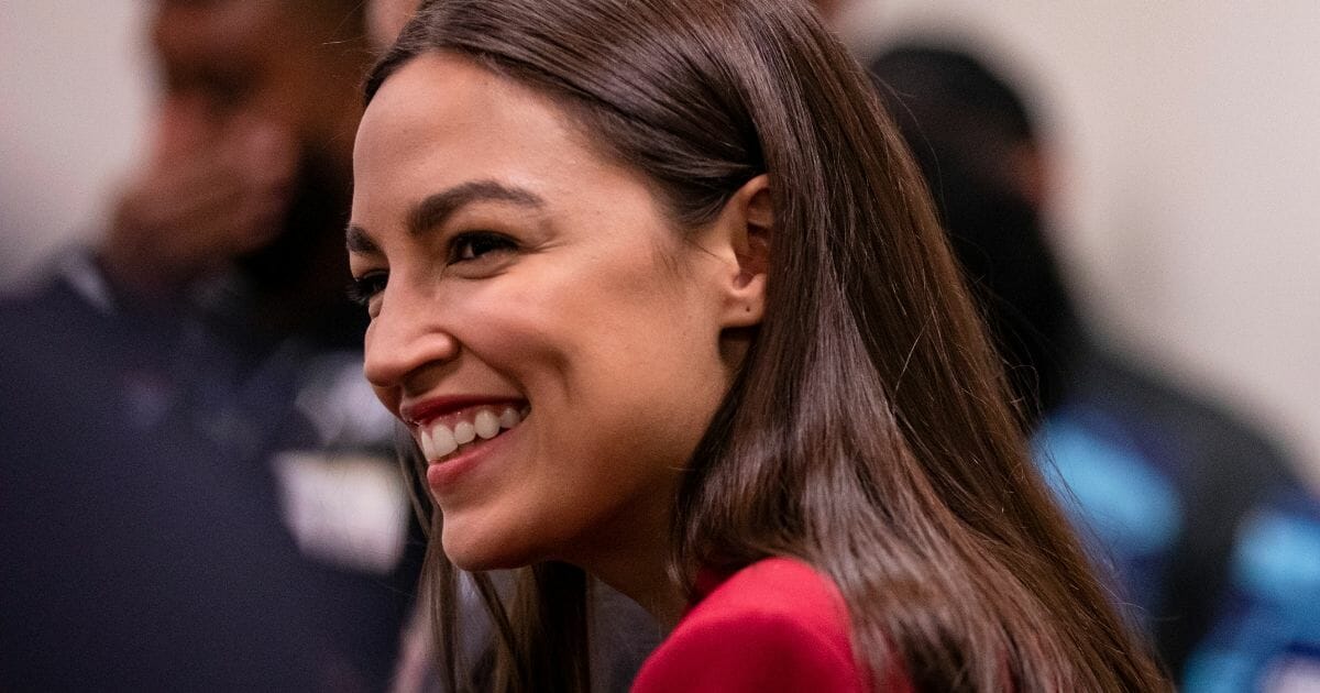 Democratic Rep. Alexandria Ocasio-Cortez of New York smiles during a news conference on Capitol Hill in Washington on Feb. 6, 2020.