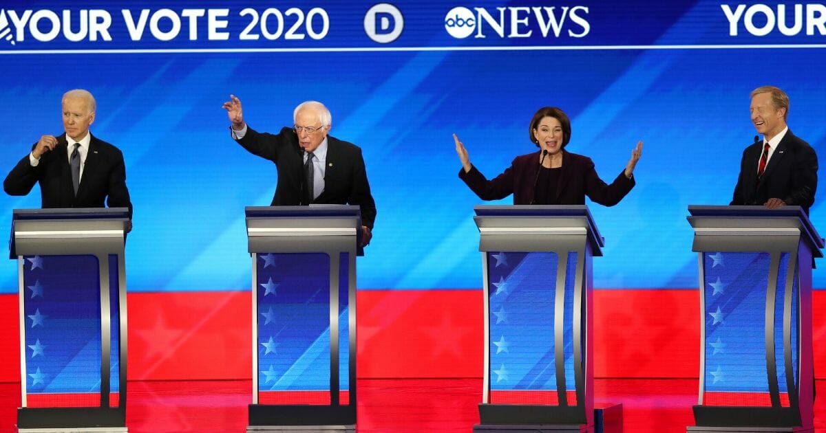 From left to right, Democratic presidential candidates former Vice President Joe Biden, Sen. Bernie Sanders (I-Vermont), Sen. Amy Klobuchar (D-Minnesota) and Tom Steyer participate in the Democratic presidential primary debate in the Sullivan Arena at St. Anselm College on Feb. 7, 2020, in Manchester, New Hampshire.