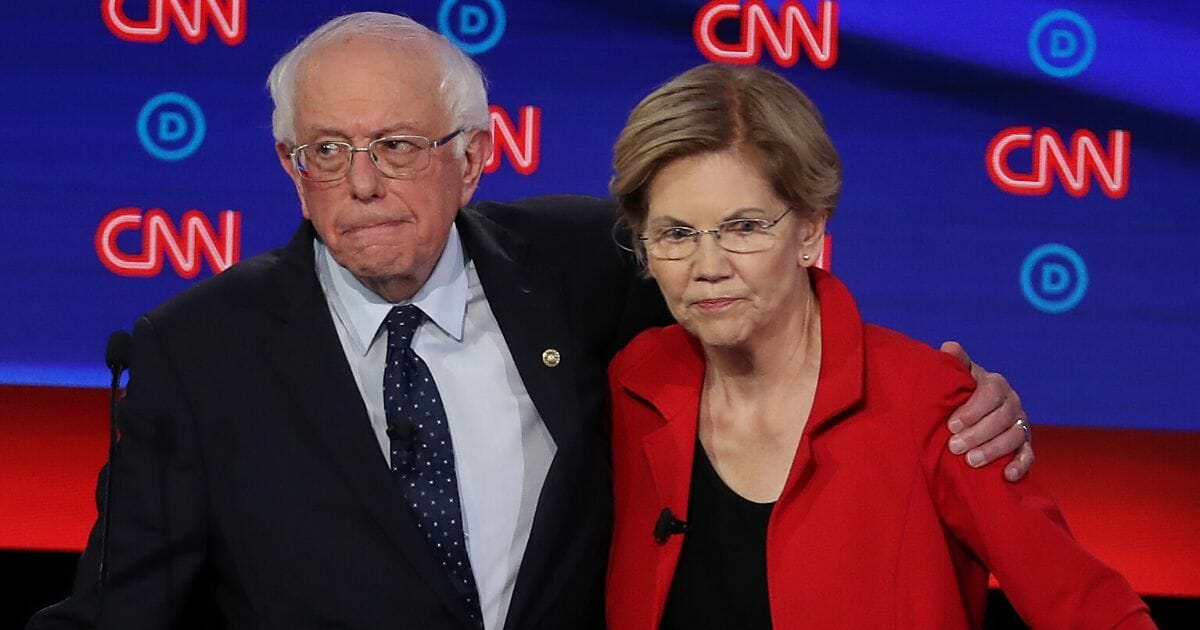 Democratic presidential candidate Sen. Bernie Sanders (I-Vermont), left, and Sen. Elizabeth Warren (D-Massachusetts) embrace after the Democratic presidential debate at the Fox Theatre July 30, 2019, in Detroit, Michigan.