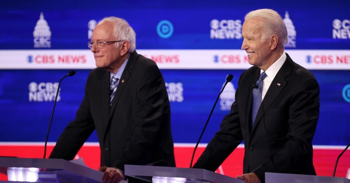 Vice President Joe Biden smiles as Sen. Bernie Sanders looks on