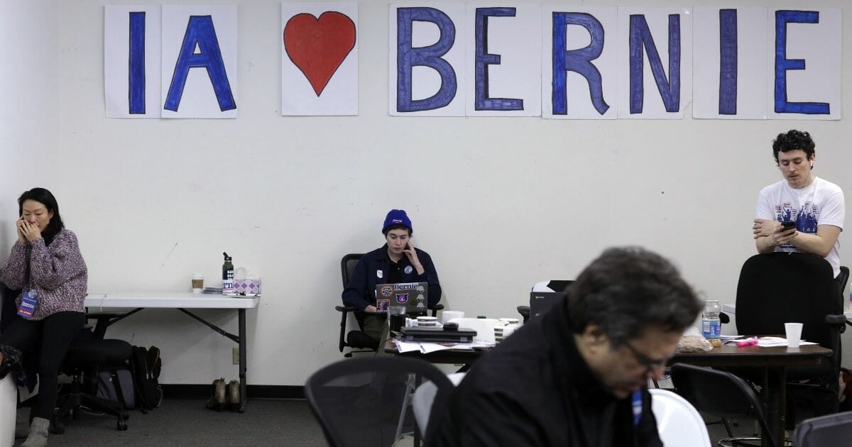 Campaign volunteers work off their phones at the campaign headquarters of Democratic presidential hopeful Sen. Bernie Sanders of Vermont on Feb. 3, 2020, in Des Moines, Iowa.